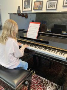 girl playing piano in MiFa Music school to learn piano