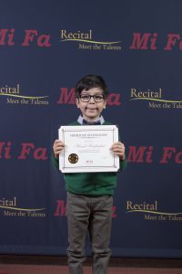 kids standing with certificate